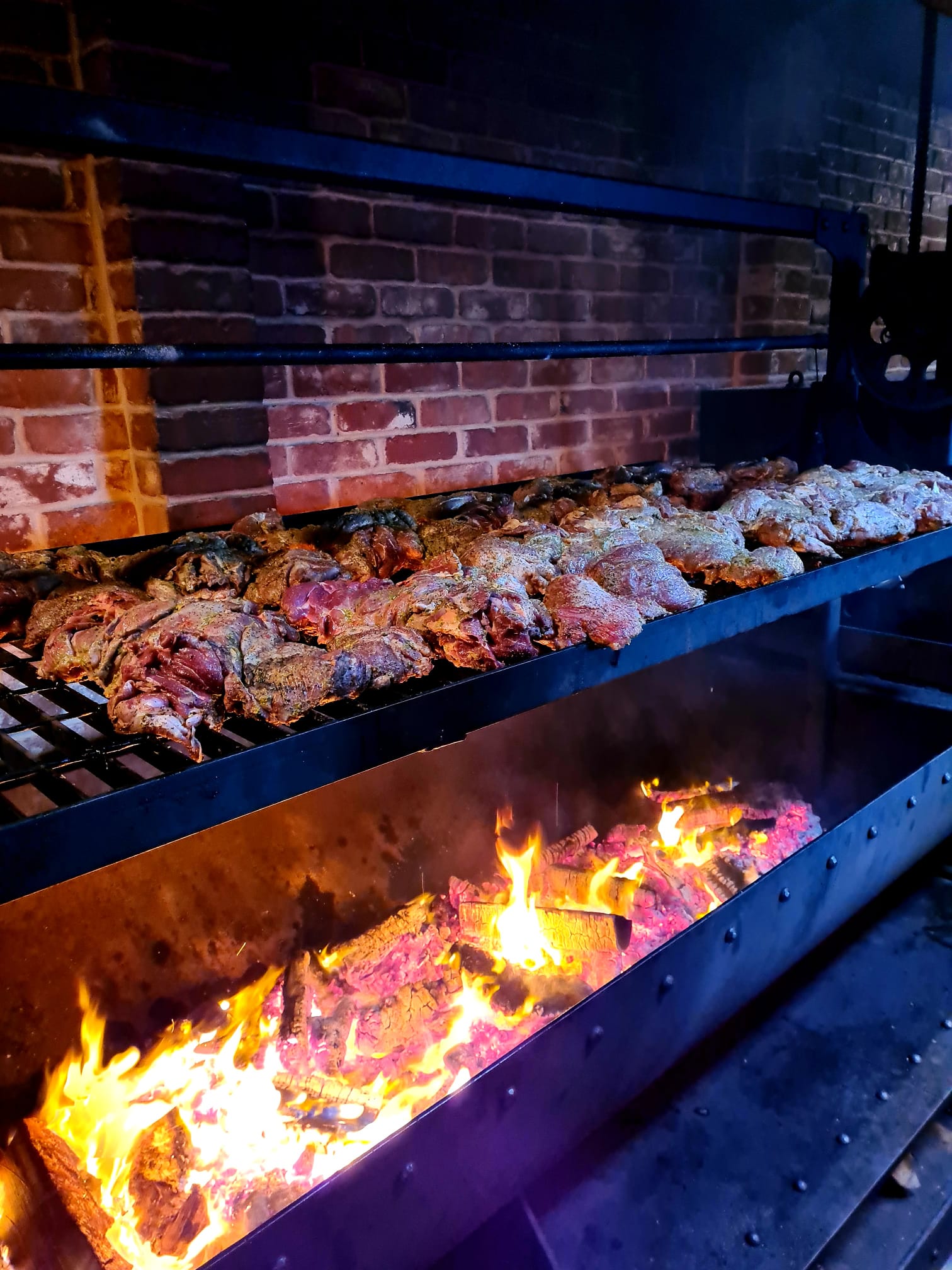 Butterflied legs of lamb on the fire